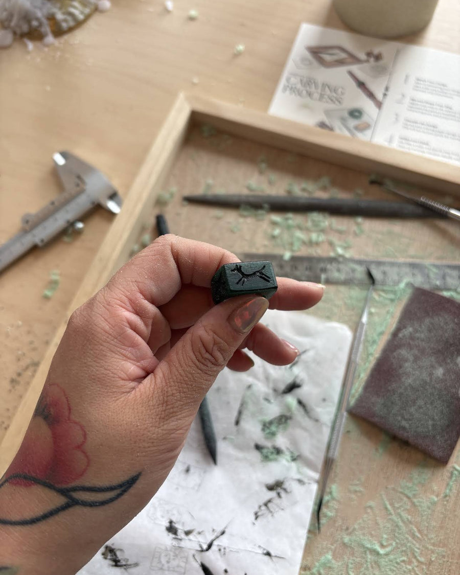 Hand-carved wax signet ring with a running horse design, made at a Nūrain workshop
